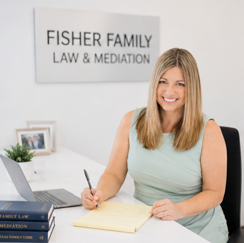Family law attorney Christy M. Fisher sitting at her desk, smiling and taking notes during a legal consultation.