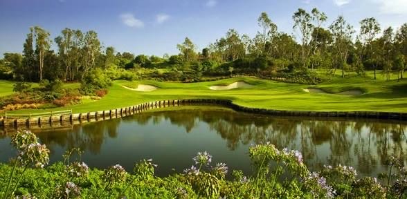 Scenic view of Suntree Country Club golf course featuring a water hazard, manicured fairways, sand bunkers, and lush landscaping in Suntree, Florida.